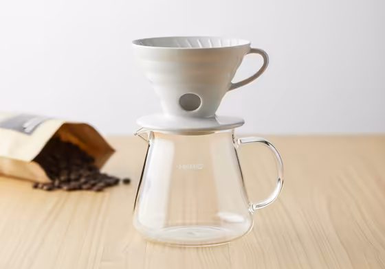 A Hario V60 dripper sitting perfectly on top of a classic beehive-shaped Hario V60 glass carafe.