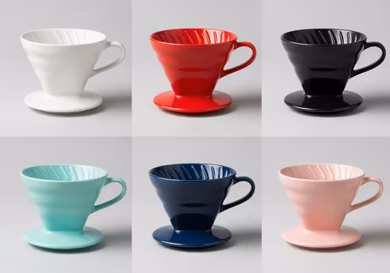 An array of Hario V60 ceramic drippers in various colors like white, red, matte black, and turquoise.