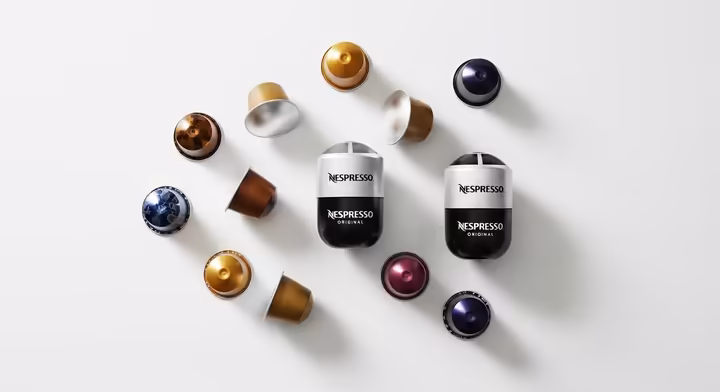 A collection of colorful Nespresso Original and Vertuo line coffee pods arranged neatly on a clean white surface.