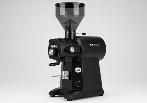 A clean, studio shot of a black Bunn G3 bulk coffee grinder, known for its reliability and durability.
