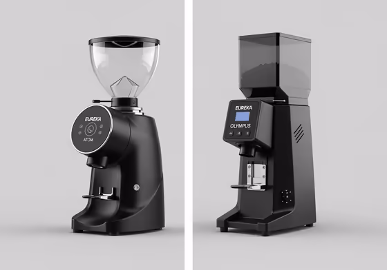 A comparison photo showing the sleek, quiet Eureka Atom 75 next to the larger, more powerful Eureka Olympus 75 grinder.